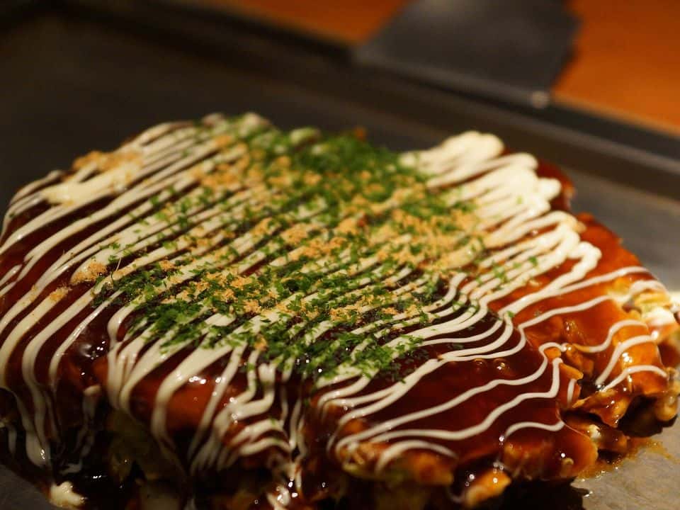 Okonomiyaki: clătită japoneză cu varză, morcov și ou, gata de servit